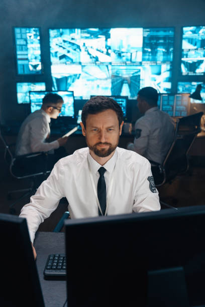 istock The operator of the security service, security, at his workplace in front of the monitors. 1311088383