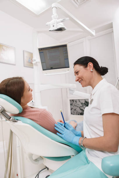 istock Female patient at dental clinic 1311090104