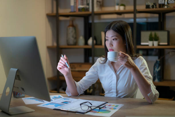 istock Asian female working on the personal computer late at night. 1311091176