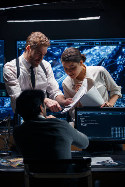 istock Three FBI special agents are holding a meeting in their office. 1311092964