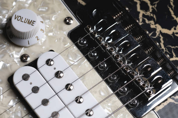 istock Guitar fretboard with tuning pegs and strings on a gray background. Close-up 1311093104