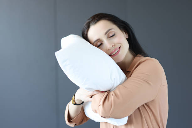 istock Woman standing in office with her head on pillow 1311093149