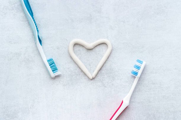 istock Teeth hygiene. Toothbrush with heart shape made of toothpaste, top view 1311093867
