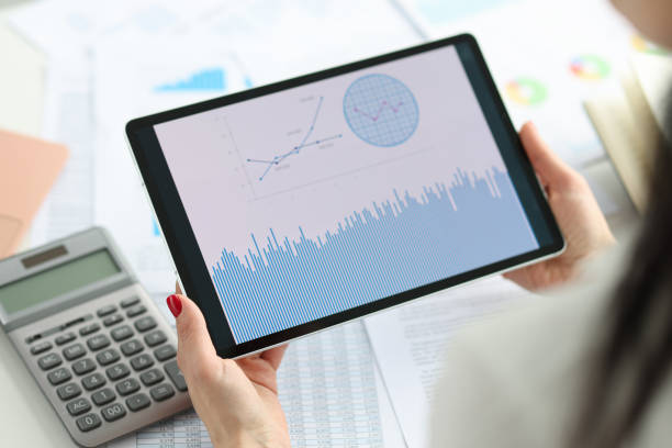 Female hands hold tablet with business indicators. Statistics and analytics in business concept