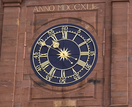 Large clock with Roman numerals of the town hall in Wissembourg. Alsace, Grand Est, France.