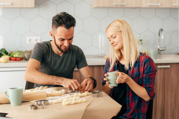 istock man and woman cooking 1311096085