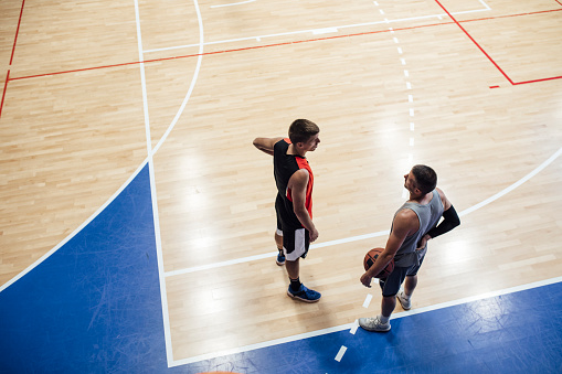 Two basketball players chatting on the court after the match