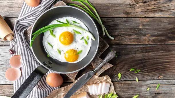 scrambled eggs with lard on a frying pan, Ukrainian or belorussian food cuisine traditional dish, banner, catering menu recipe place for text, top view.