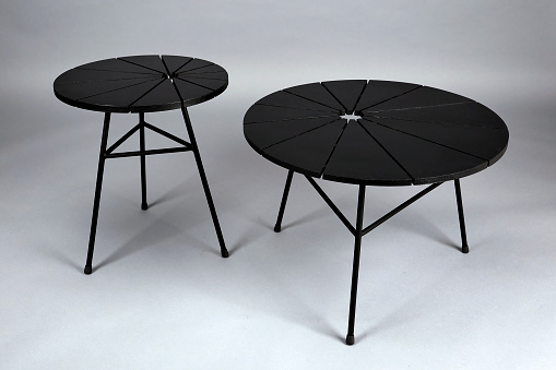 Two black round wooden tables