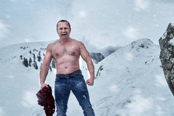 istock Shirtless man in the mountains winter time 1311097729