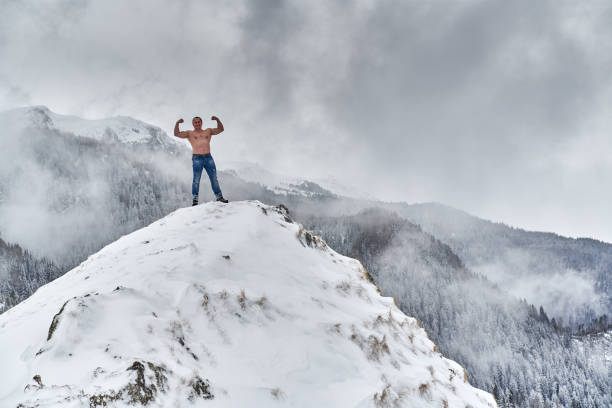istock Shirtless man in the mountains winter time 1311097731