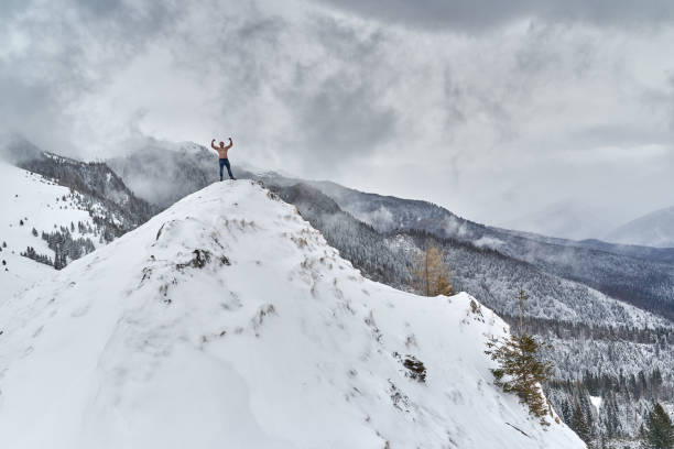 istock Shirtless man in the mountains winter time 1311097740