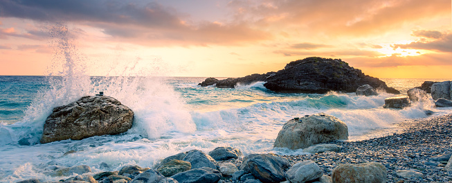 Fresh Sunrise on the sea - Sea wave crash on big stone in beautiful white splashes. Seascape. Panoramic view of the seashore
