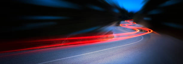 panoramic - cars light trails at night in a curve  asphalt road at night, long exposure image - land vehicle in a row action motion imagens e fotografias de stock