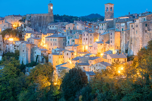 Panoramic view of Sorano in the evening night with old tradition buildings and illumination. Old small town in the Province of Grosseto, Tuscany (Toscana), Italy, Europe