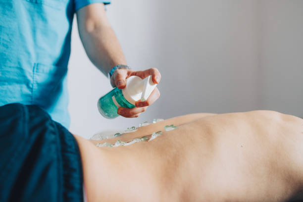 istock Physical Therapist Using Ultrasound to Treat the Patient's back 1311098285