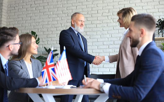 United Kingdom and American leaders shaking hands on a deal agreement