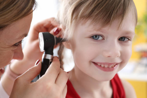 istock Little child with doctor exam hearing deviation 1311099735