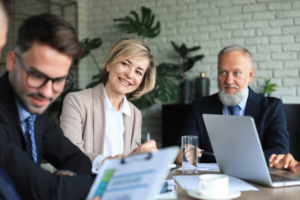 istock Group of business partners discussing ideas and planning work in office. 1311100123