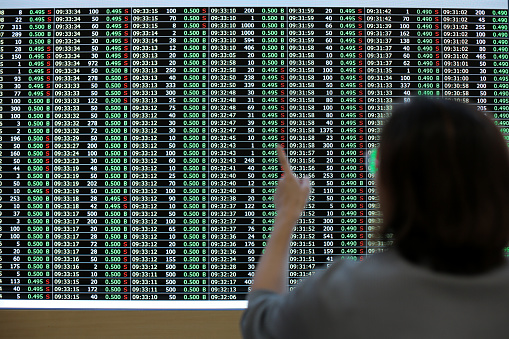 An Asian woman in financial market exchange centre.