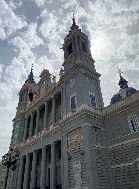 Perspective of the Almudena Cathedral with a sky full of clouds stock photo