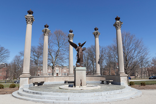 Muncie - Circa March 2021: Beneficence statue on the campus of Ball State University. The five pillars represent the Ball brothers and Beneficence's hand stretches to welcome new students.