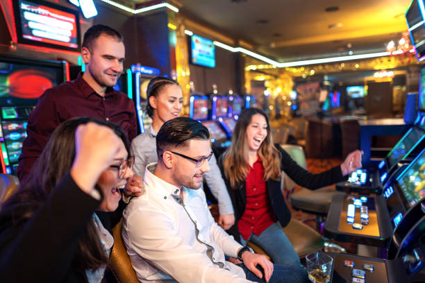 istock Group of people playing slot machines 1311102027