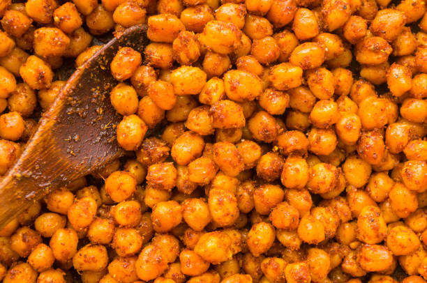istock Cooking chickpeas with spices in a pan, close-up 1311102145