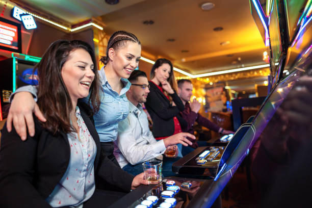 istock Group of people playing slot machines 1311102281