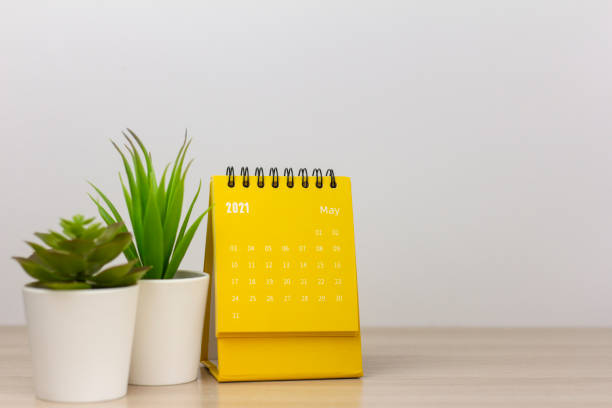 istock Desktop calendar for May 2021. Calendar and clock for planning, assigning, organizing, and managing each date. 1311102580