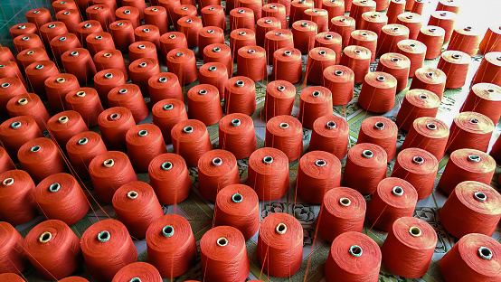 Orange yarn for weaving various types of fabrics in Thailand