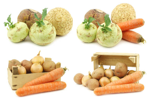 Mixed root vegetables and some in a wooden crate on a white background