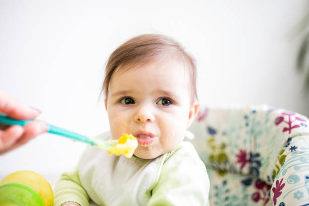 istock Mother feeding her baby with spoon 1311104271