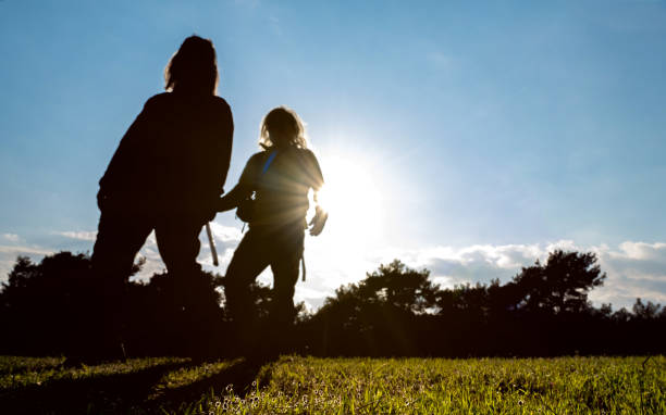 Man with a cane in his hand, 60 years old, 55 years old woman walking side by side.daylight hitting the man's arm