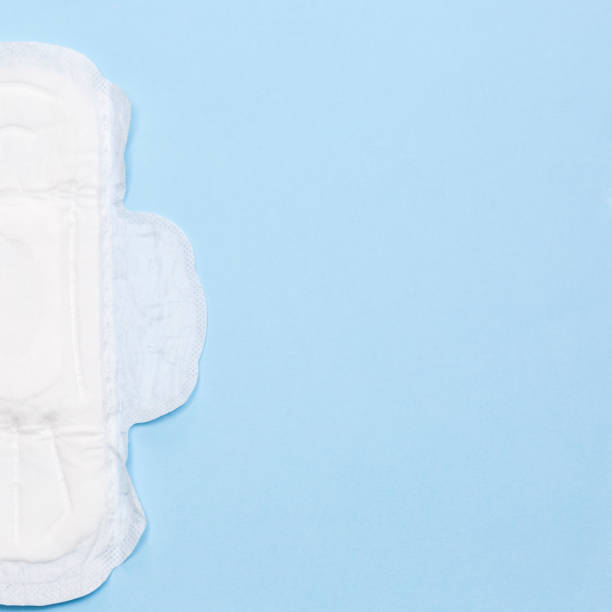 istock Half of white sanitary napkin on the blue background 1311106247