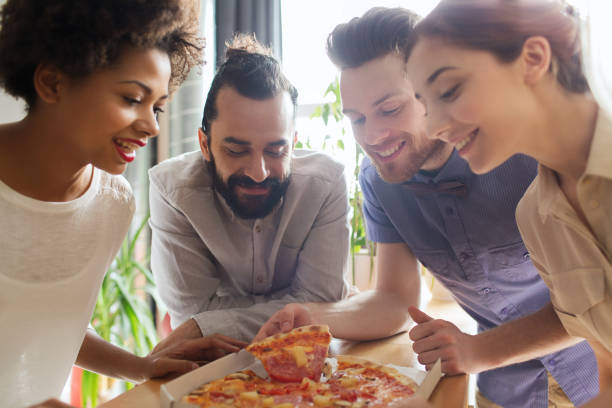 istock happy business team eating pizza in office 1311108006