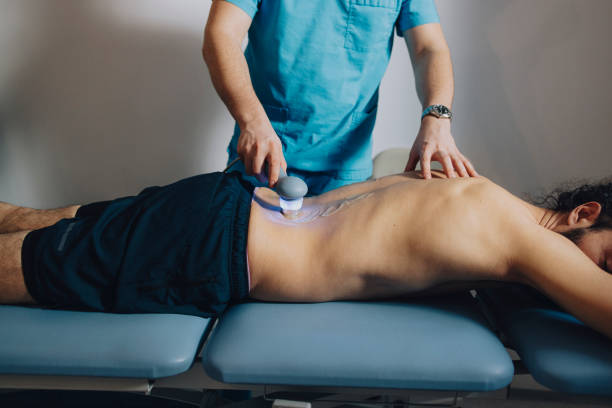 istock Physical Therapist Using Ultrasound to Treat the Patient's back (close up) 1311108455