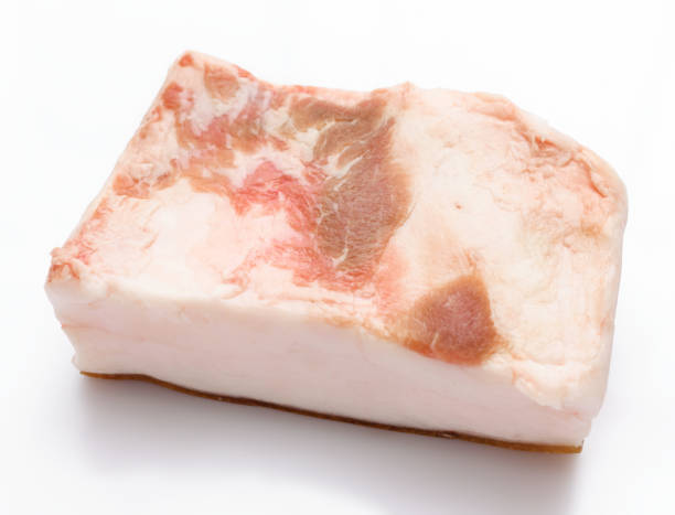 istock raw lard piece on white background, pork fat 1311109224