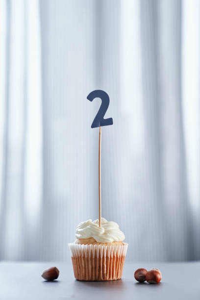 istock Minimalistic birthday cupcake with number 2 two 1311109593