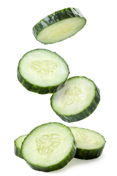 Cucumber slices fall on a white background. Isolated Cucumber slices fall close-up on a white background. Isolated cucumber slice stock pictures, royalty-free photos & images