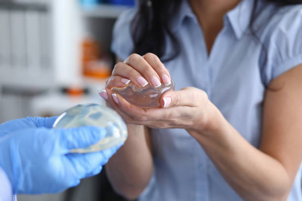 istock Doctor demonstrates silicone breast implants to women 1311109908