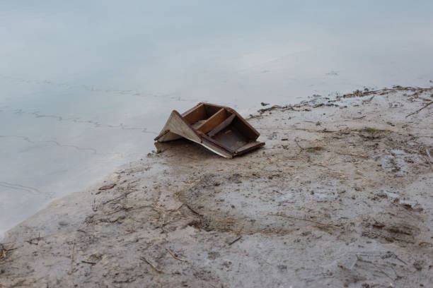 istock old chair by the river, environmental pollution 1311111285
