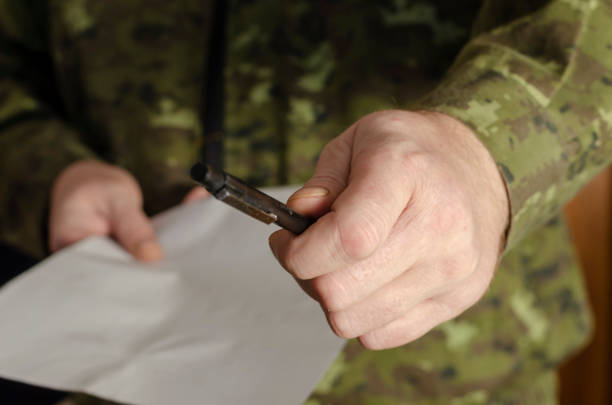 istock An officer holds out a black pen to the camera. 1311112472