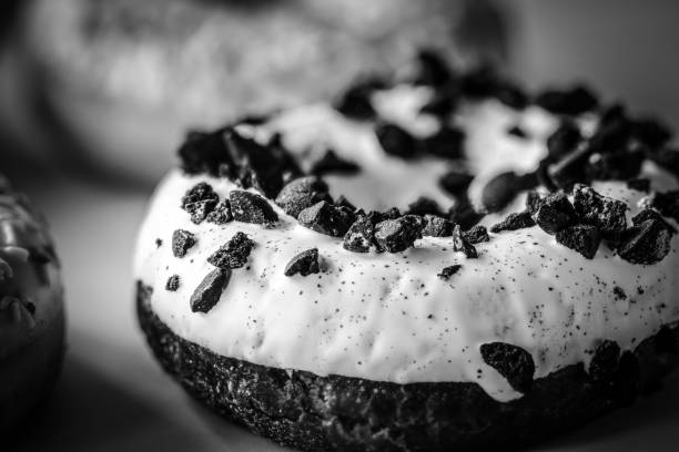 Donut with white glaze and black cookies