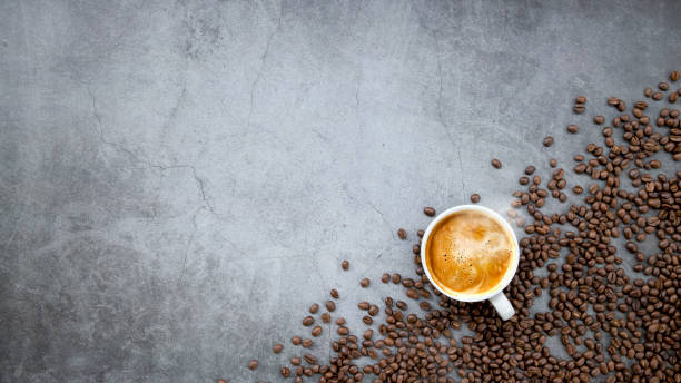 istock hot espresso and coffee beans on old cement floor background. top view. flat lay. space for text 1311114021