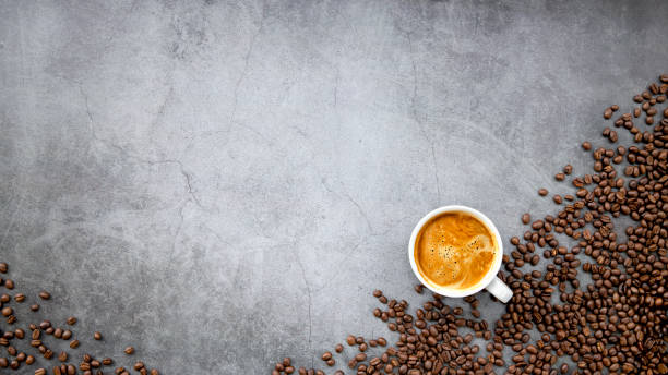 istock hot espresso and coffee beans on old cement floor background. top view. flat lay. space for text 1311114029