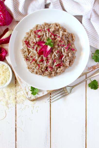 Italian risotto with radicchio and parmesan cheese on white background. stock photo