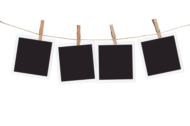 Four blank instant photo frames hanging on a rope, isolated on white background Four blank instant photo frames hanging on a rope, isolated on white background four objects photos stock pictures, royalty-free photos & images