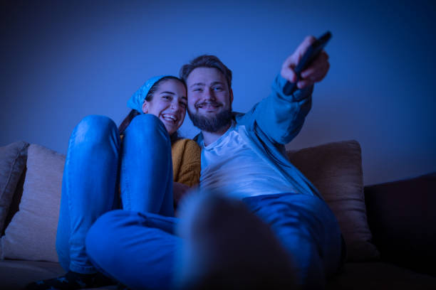 istock Pair smiling and watching movie 1311119293