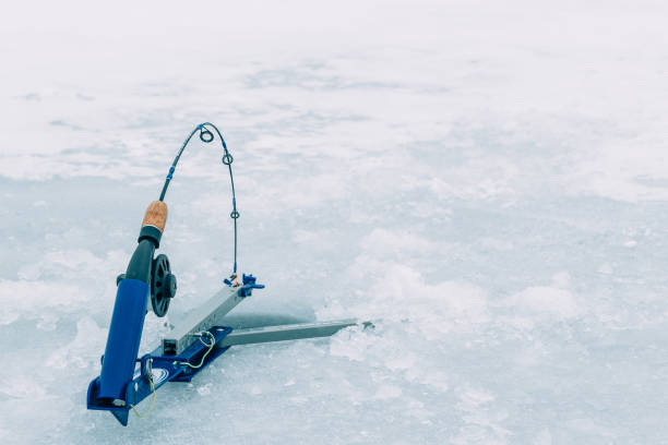 Ice Fishing Scenic winter ice fishing in the mountains of Colorado ice fishing stock pictures, royalty-free photos & images